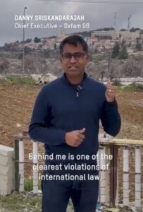 A still from a video of Danny Sriskandarajah standing in front of illegal Israeli settlements 